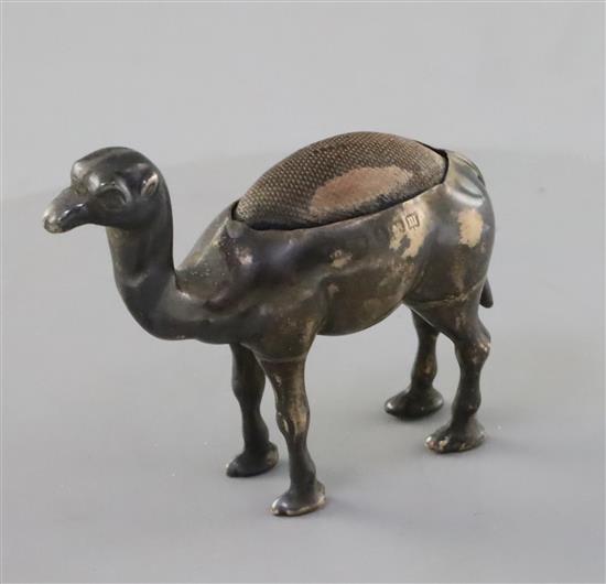 A George V novelty silver mounted pin cushion, modelled as a free-standing camel, by H.H & S, Birmingham, 1911, H.52mm.